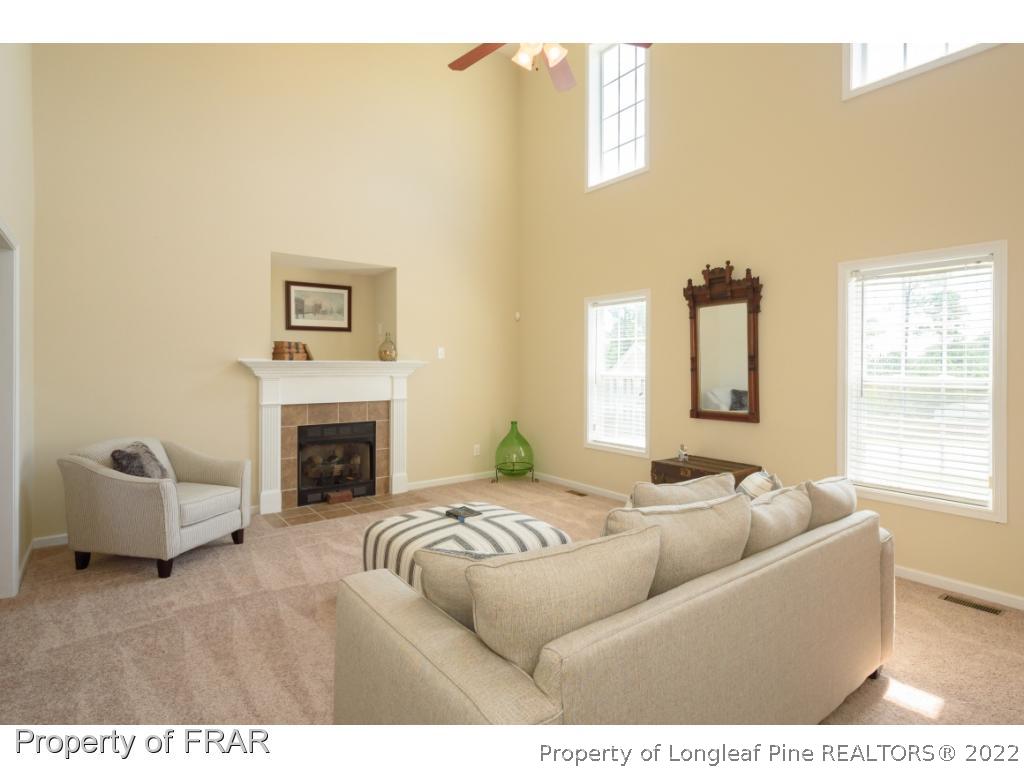 11 Lattimore Road Cameron, NC 28326 - Photo 5 of 28 a living room with furniture and a fireplace