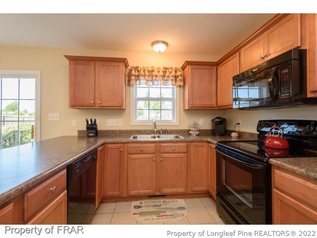 11 Lattimore Road Cameron, NC 28326 - Photo 10 of 28 a kitchen with stainless steel appliances granite countertop a sink stove and microwave