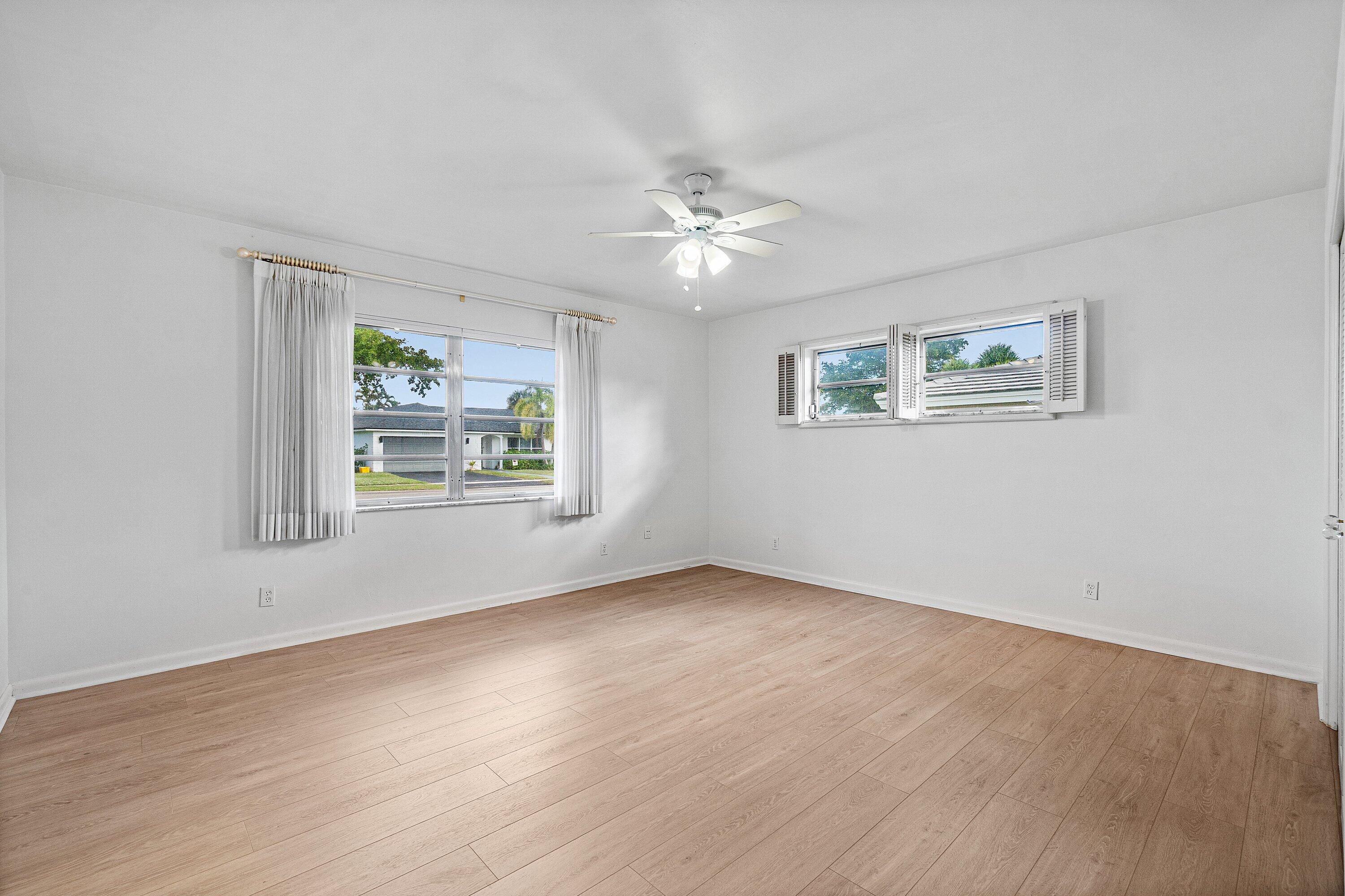 1350 Southwest 13th Place Boca Raton, FL 33486 - Photo 17 of 27 a view of an empty room with window and wooden floor