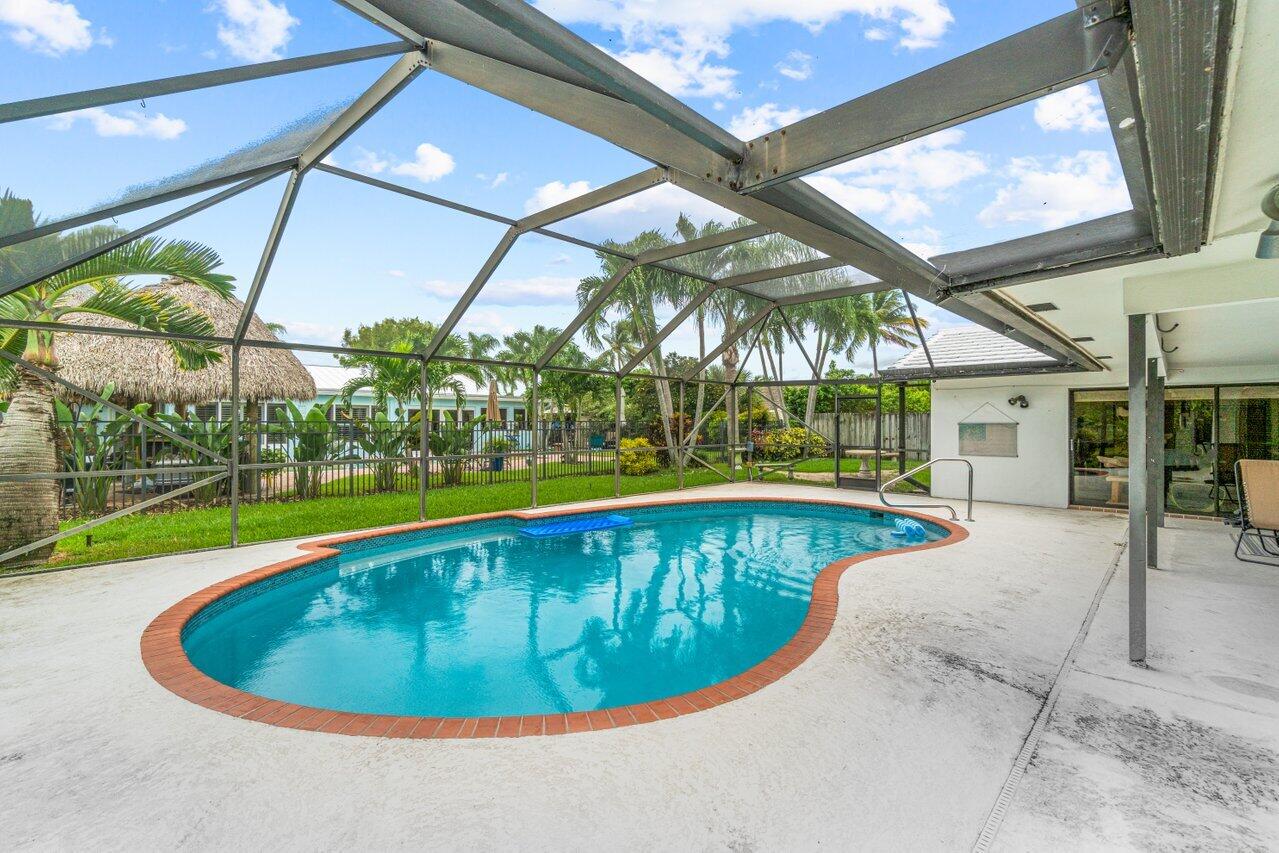 1350 Southwest 13th Place Boca Raton, FL 33486 - Photo 22 of 27 a view of a swimming pool with a patio