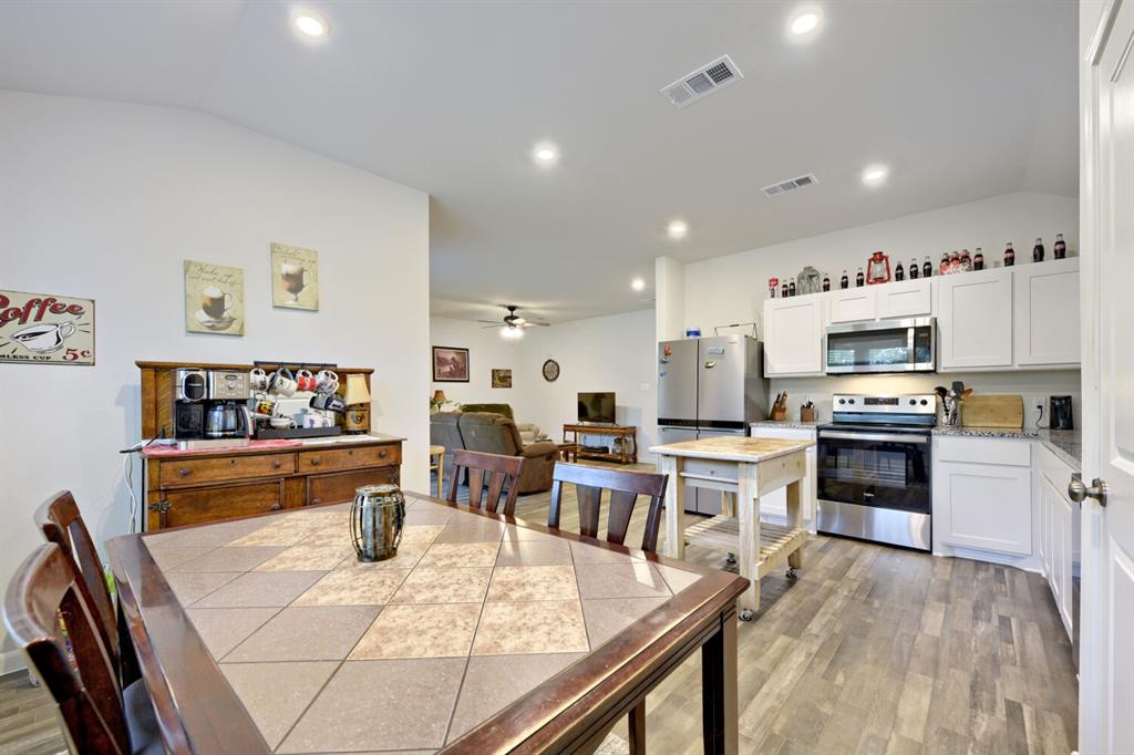 420 Jameson Springtown, TX 76082 - Photo 6 of 29 a large kitchen with cabinets table and chairs
