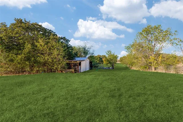 a view of a tiny house with a yard