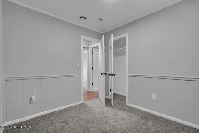 a view of a house with a door and wooden walls