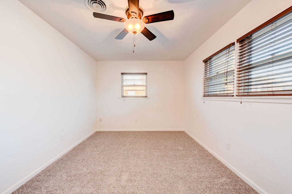 4406 26th Street Lubbock, TX 79410 - Photo 11 of 22 an empty room with windows and fan