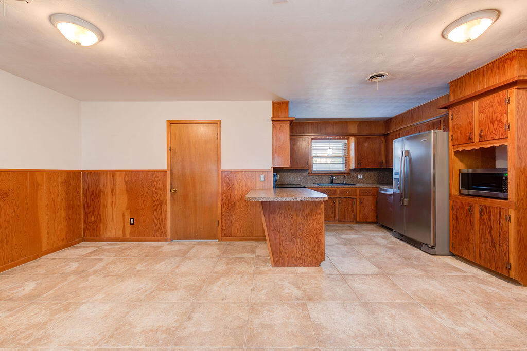 4406 26th Street Lubbock, TX 79410 - Photo 16 of 22 a kitchen with stainless steel appliances a refrigerator and microwave