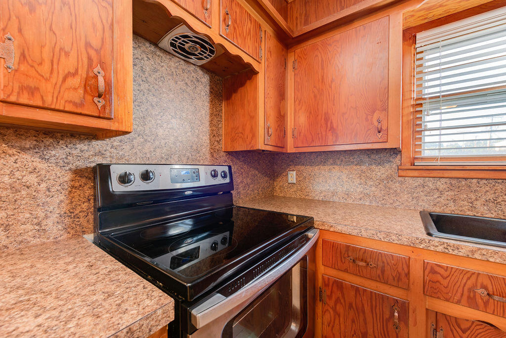 4406 26th Street Lubbock, TX 79410 - Photo 19 of 22 a stove top oven sitting inside of a kitchen