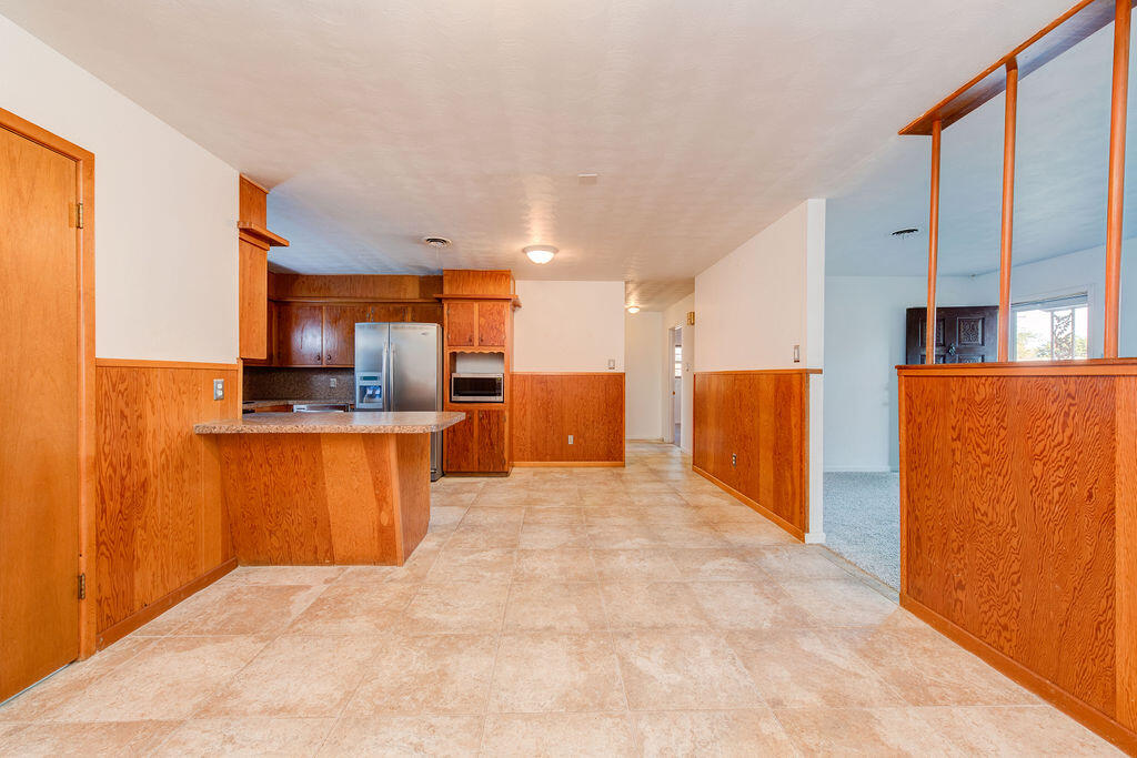4406 26th Street Lubbock, TX 79410 - Photo 3 of 22 a view of kitchen with stainless steel appliances kitchen island granite countertop a refrigerator and a stove top oven