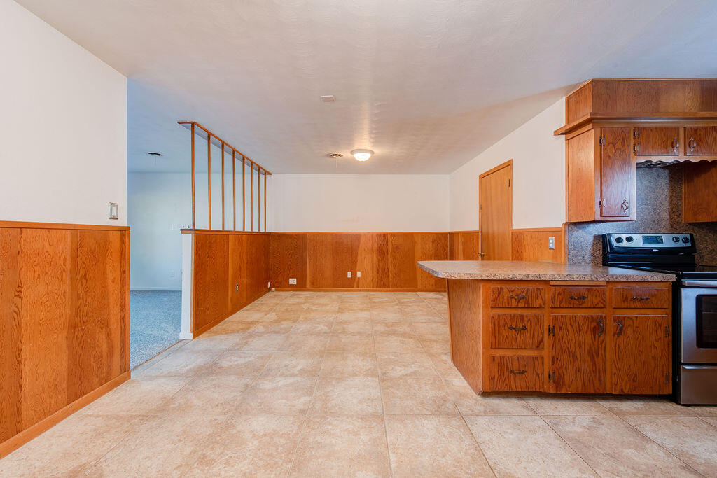 4406 26th Street Lubbock, TX 79410 - Photo 4 of 22 a view of kitchen with stainless steel appliances granite countertop a stove and a refrigerator