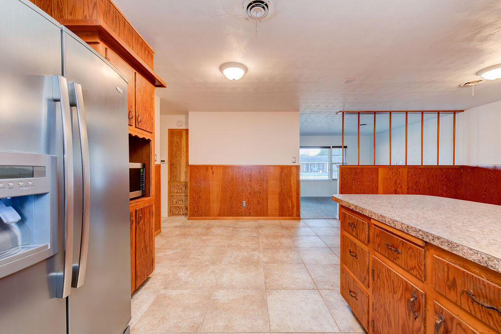 4406 26th Street Lubbock, TX 79410 - Photo 9 of 22 a kitchen with stainless steel appliances granite countertop a refrigerator and a sink