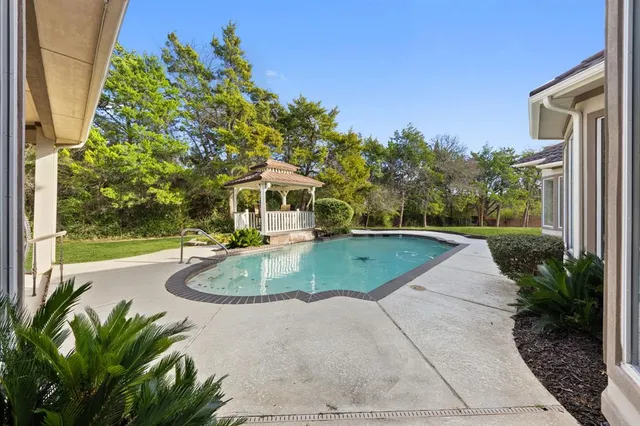 a view of a patio with a table and chairs