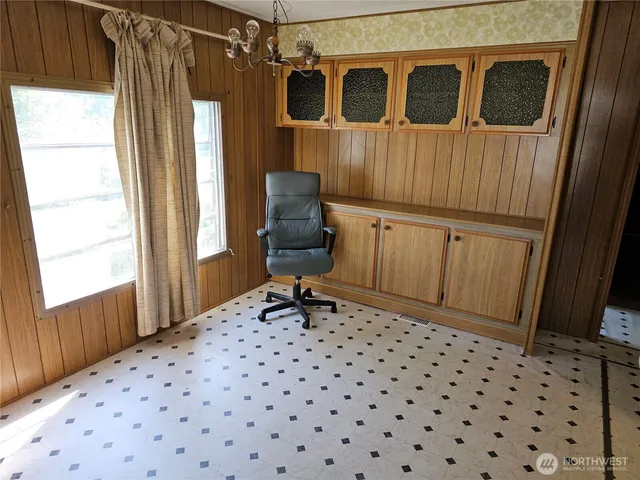 a view of an empty room with a fireplace and a window