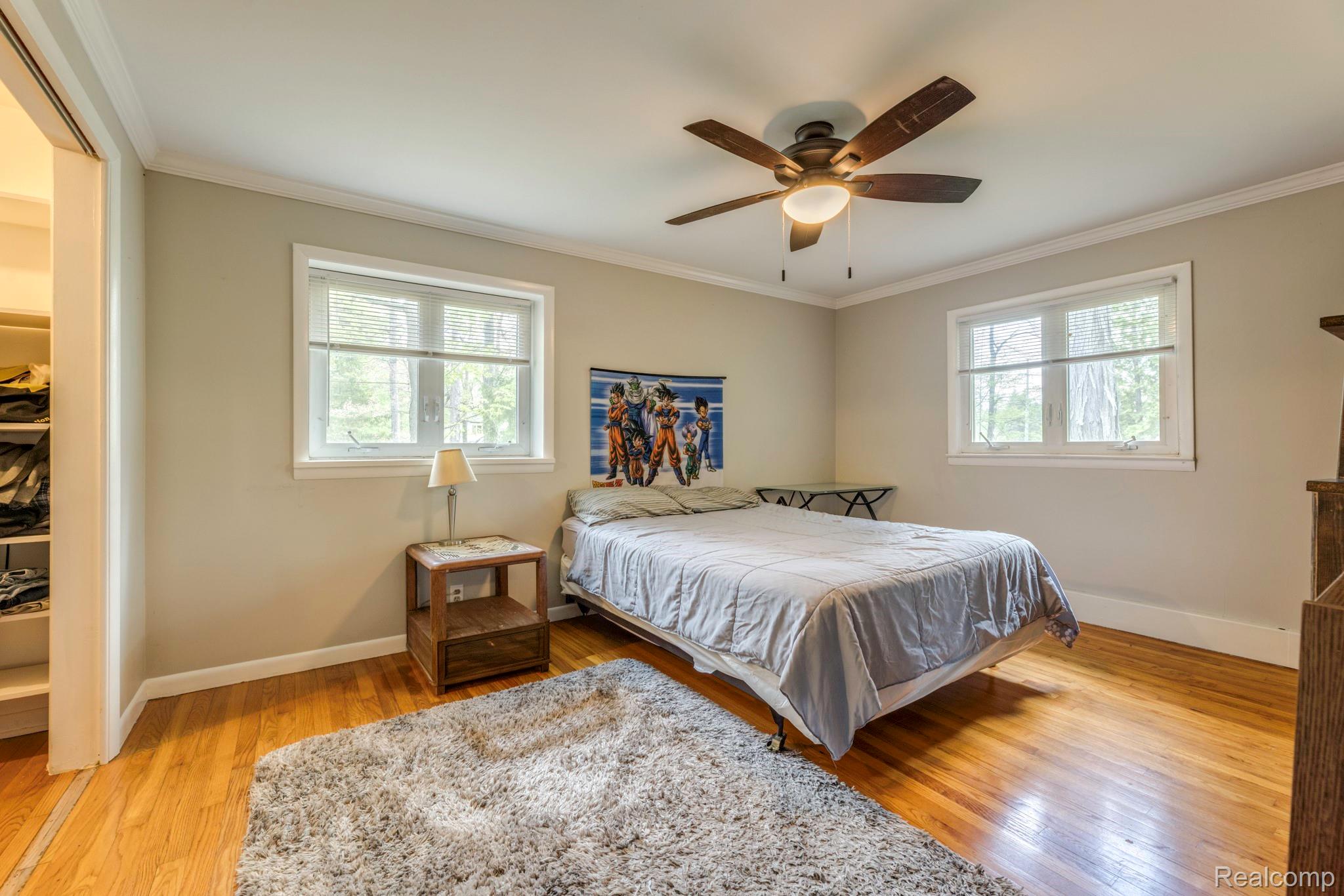3560 North Road North Street, MI 48049 - Photo 39 of 53 Bedroom with light wood-type flooring, crown molding, and ceiling fan
