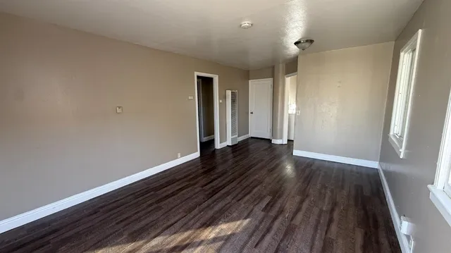 a view of hallway with wooden floor