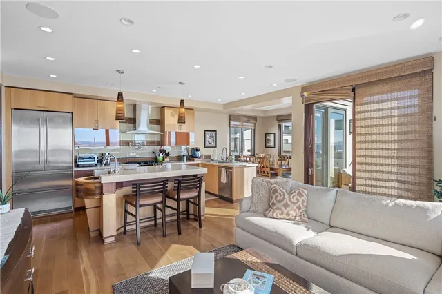 a living room with stainless steel appliances kitchen island granite countertop furniture and a kitchen view