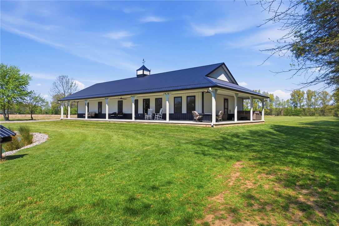 1602 Westboro Road Blanchester, OH 45107 - Photo 2 of 81 This expansive estate features a charming exterior with a spacious porch and lush green surroundings.