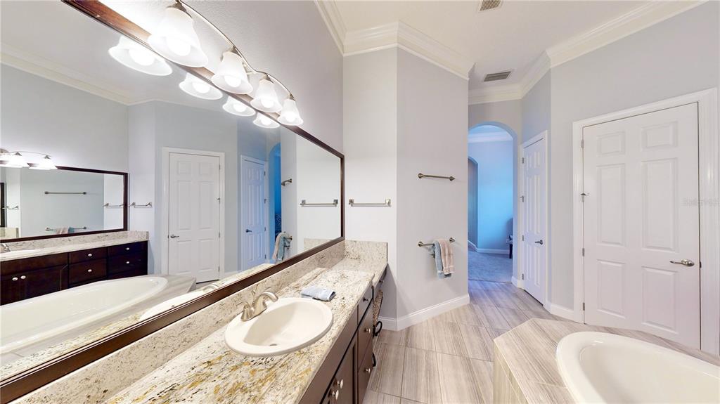 6219 Tiroco Way Windermere, FL 34786 - Photo 14 of 72 a spacious bathroom with a sink a large mirror and a shower