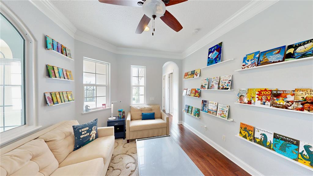 6219 Tiroco Way Windermere, FL 34786 - Photo 16 of 72 a living room with furniture and a book shelf