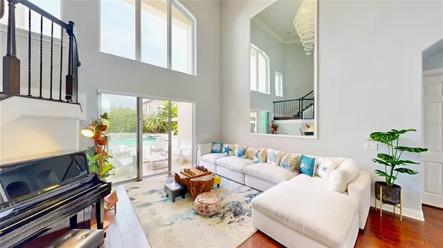 a kitchen with a stove a sink dishwasher a dining table and chairs with wooden floor