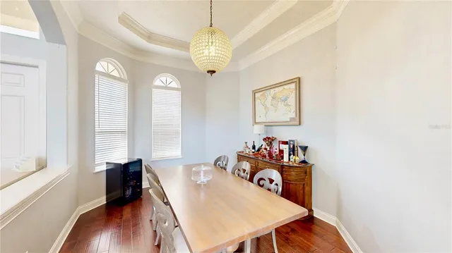 a view of a dining room with furniture a livingroom and chandelier