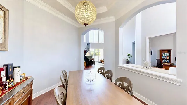 a living room with furniture flat screen tv and a large window