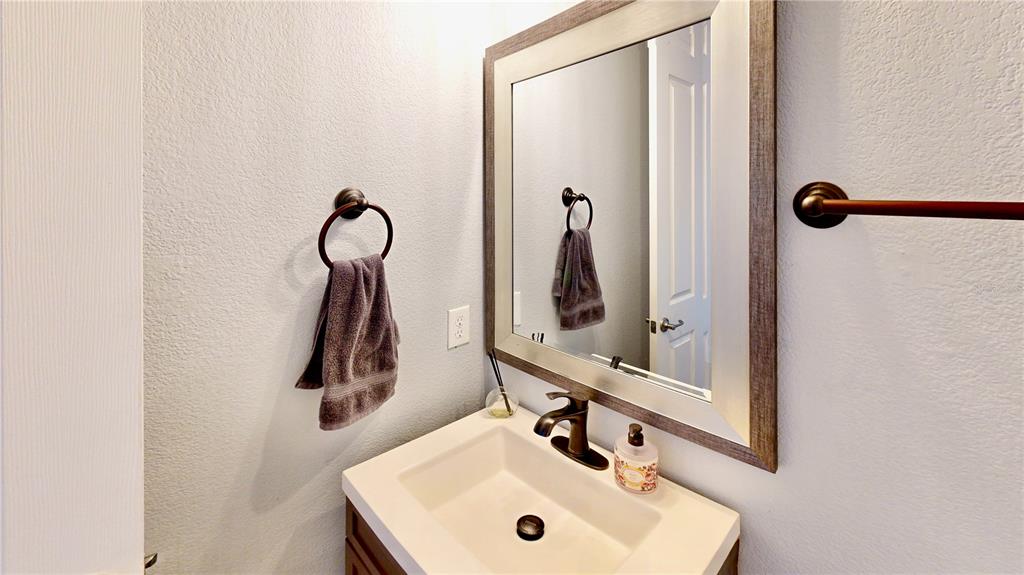 6219 Tiroco Way Windermere, FL 34786 - Photo 34 of 72 a bathroom with a sink and a mirror