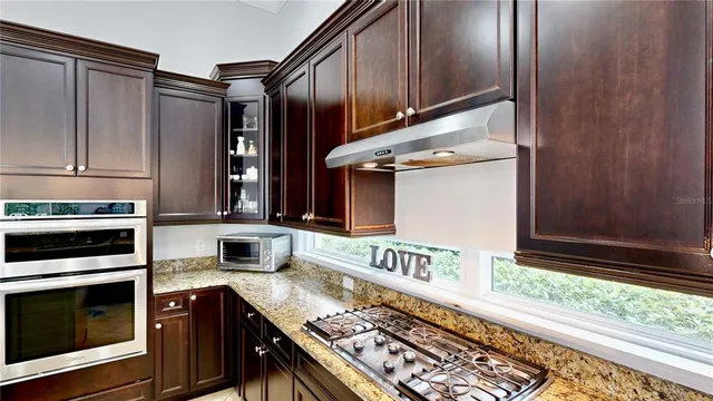 a spacious bathroom with a granite countertop sink mirror and a bathtub