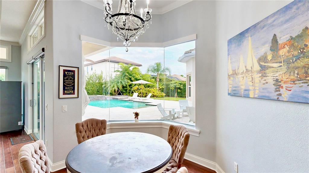 6219 Tiroco Way Windermere, FL 34786 - Photo 39 of 72 a view of a dining room with furniture a livingroom and chandelier