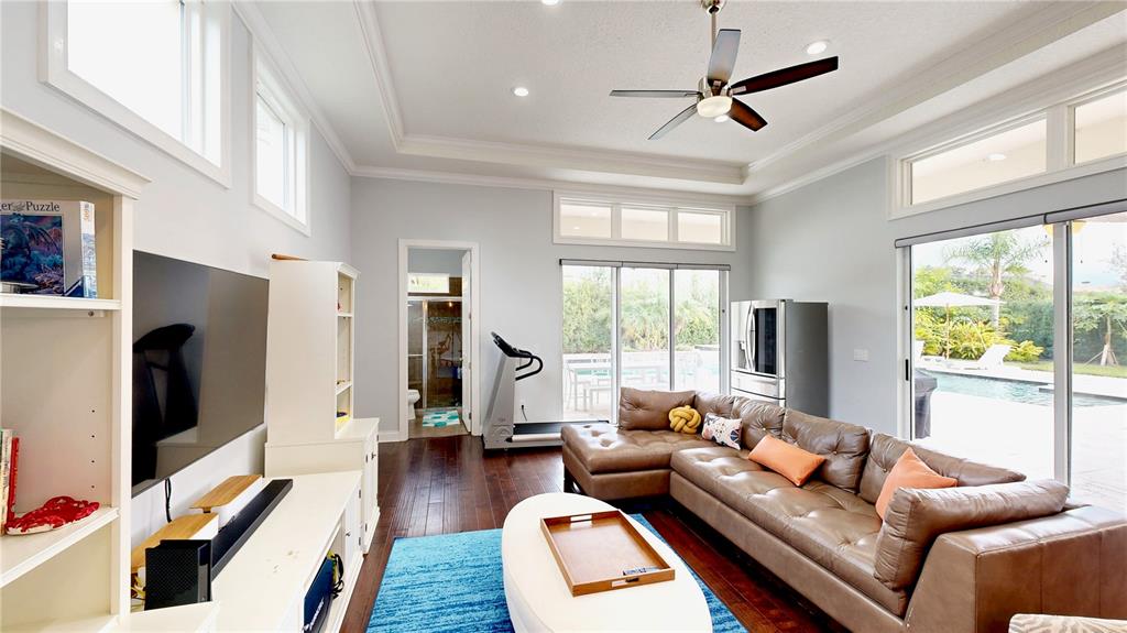 6219 Tiroco Way Windermere, FL 34786 - Photo 40 of 72 a living room with furniture flat screen tv and a large window