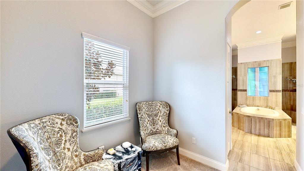 6219 Tiroco Way Windermere, FL 34786 - Photo 44 of 72 a bedroom with a bed and a chair