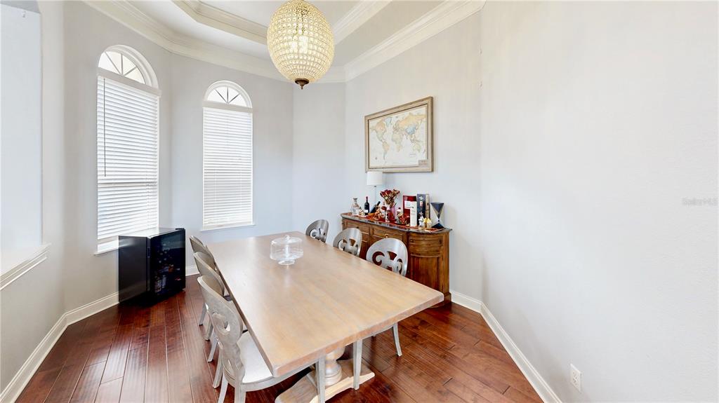 6219 Tiroco Way Windermere, FL 34786 - Photo 5 of 72 a view of a dining room with furniture and wooden floor