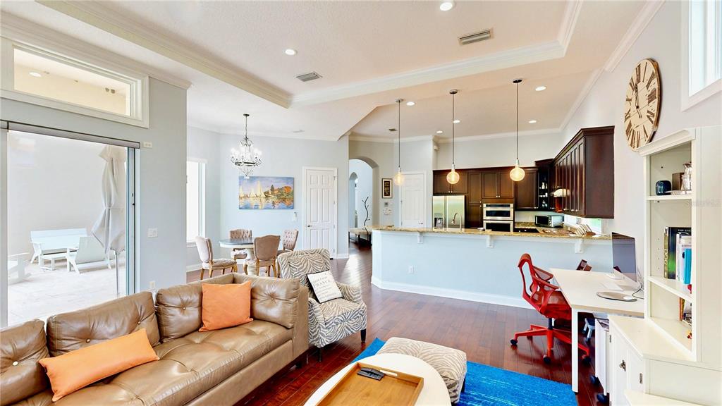 6219 Tiroco Way Windermere, FL 34786 - Photo 6 of 72 a living room with furniture kitchen view and a wooden floor