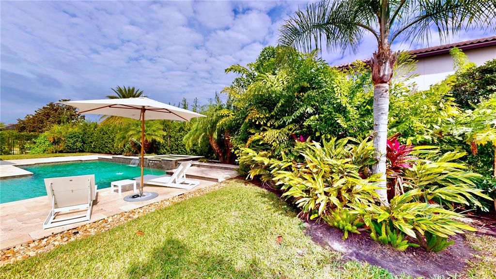6219 Tiroco Way Windermere, FL 34786 - Photo 67 of 72 a view of a swimming pool with a table and chairs