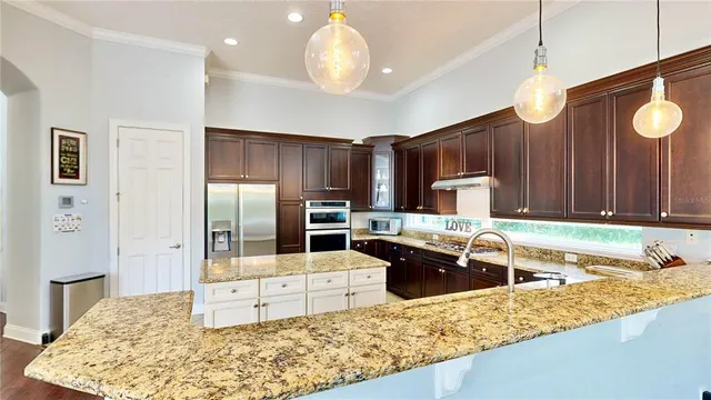 a living room with furniture and kitchen view