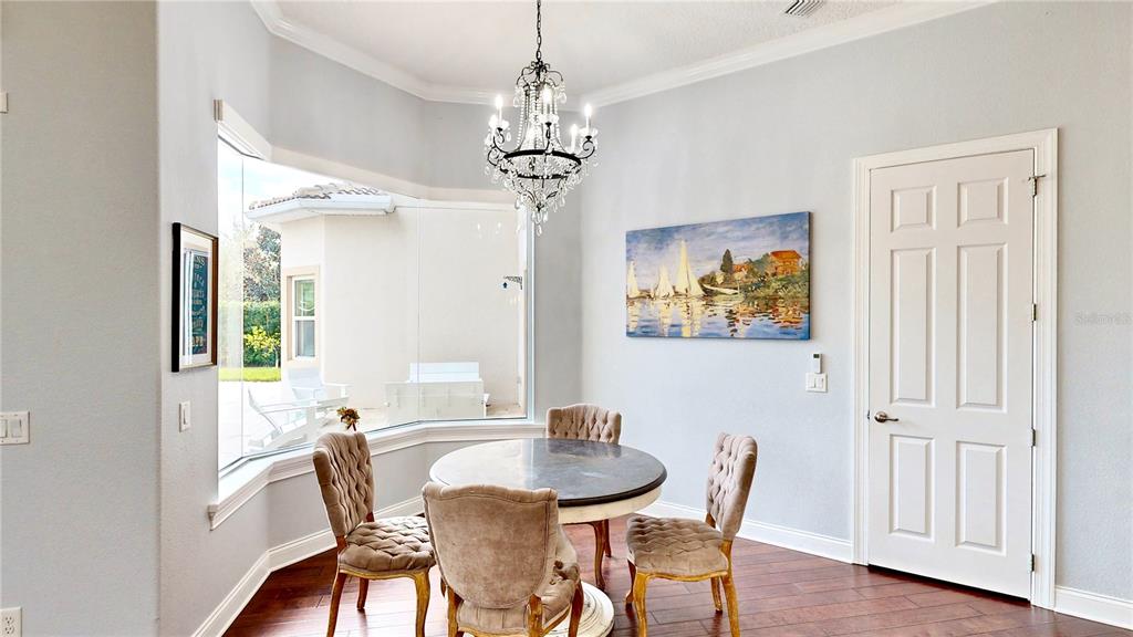6219 Tiroco Way Windermere, FL 34786 - Photo 10 of 72 a view of a dining room with furniture wooden floor and chandelier
