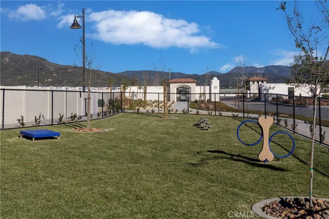 a view of a patio with table and chairs with wooden floor and fence