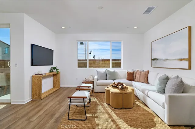 a living room with furniture potted plant and a window