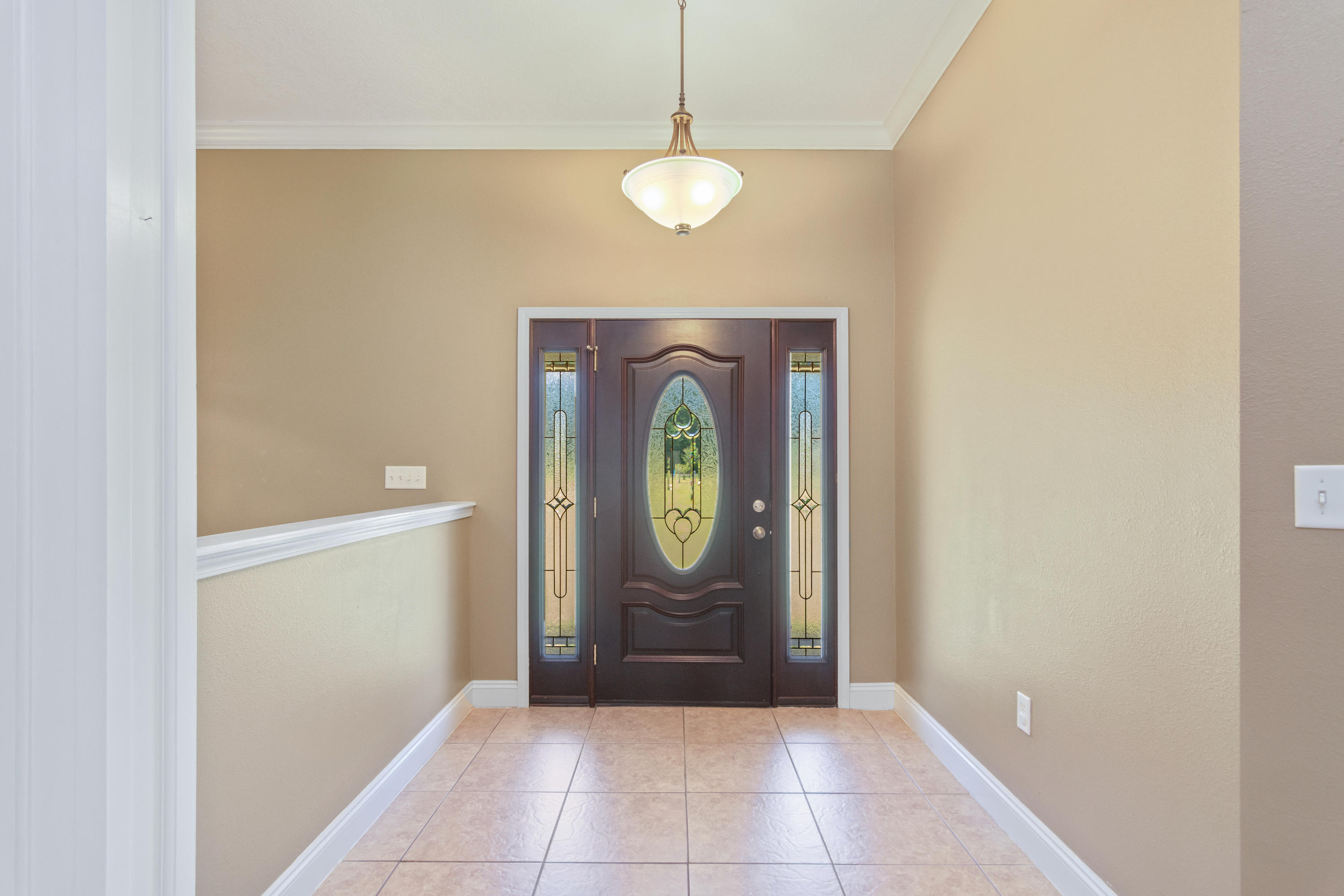 6589 Old River Road Baker, FL 32531 - Photo 11 of 49 a view of an entryway with a chandelier