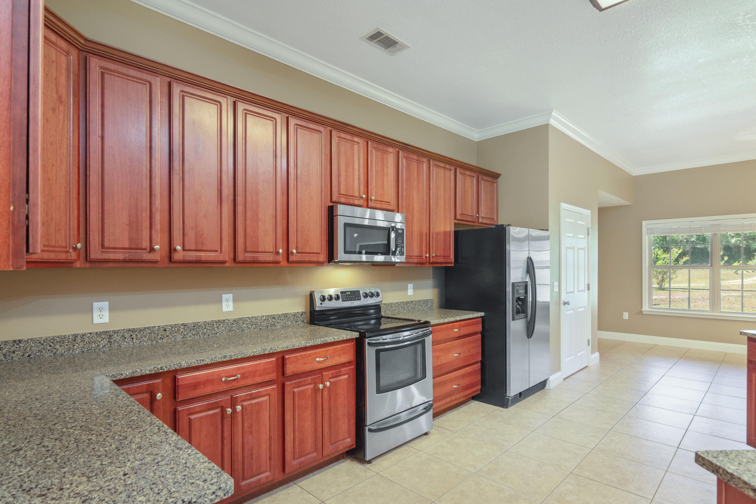 6589 Old River Road Baker, FL 32531 - Photo 18 of 49 a kitchen with stainless steel appliances granite countertop a refrigerator stove and sink
