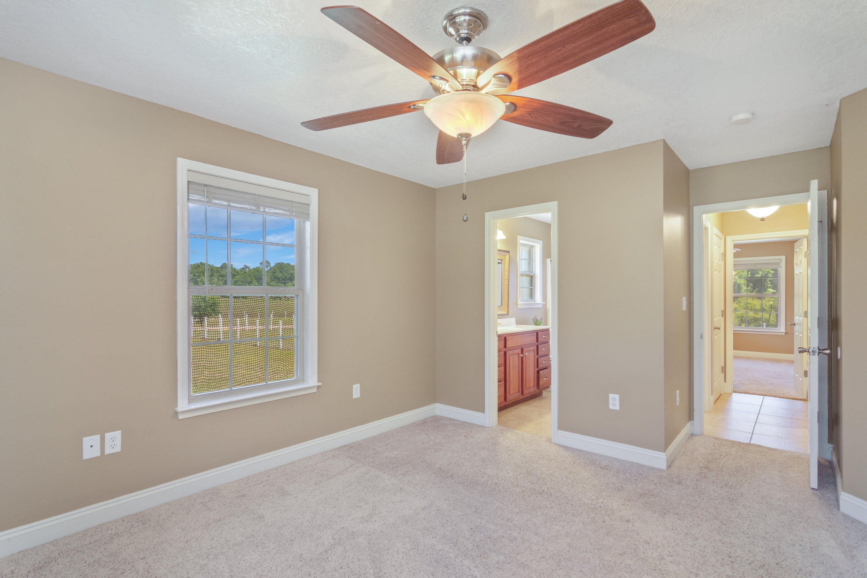 6589 Old River Road Baker, FL 32531 - Photo 24 of 49 an empty room with fan and windows