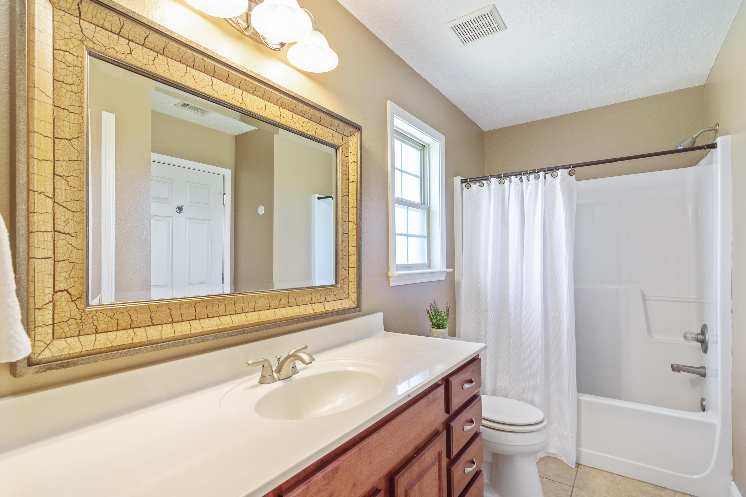 6589 Old River Road Baker, FL 32531 - Photo 26 of 49 a bathroom with a sink toilet and shower