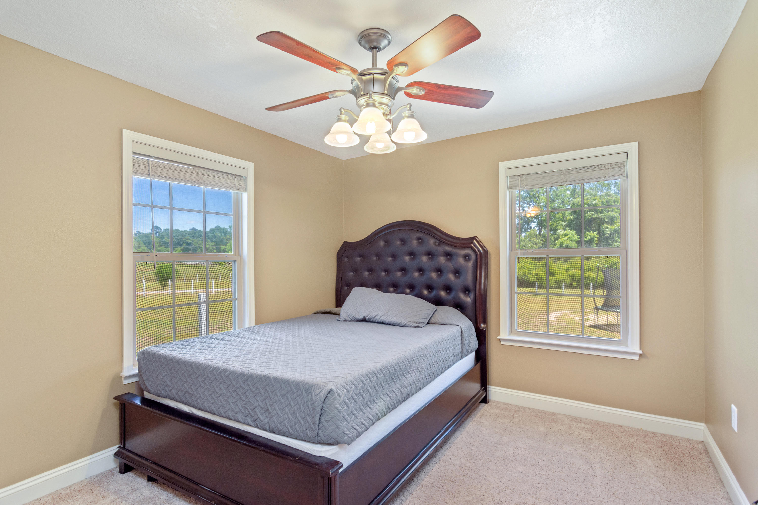 6589 Old River Road Baker, FL 32531 - Photo 28 of 49 a bedroom with a bed and a large window