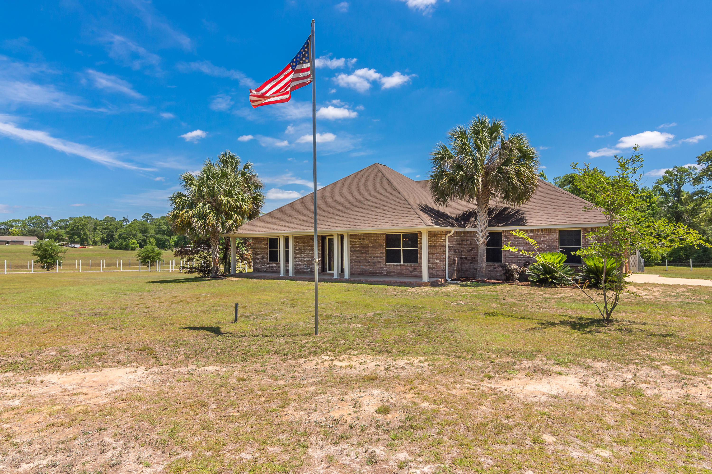 6589 Old River Road Baker, FL 32531 - Photo 3 of 49 a front view of a house with a garden