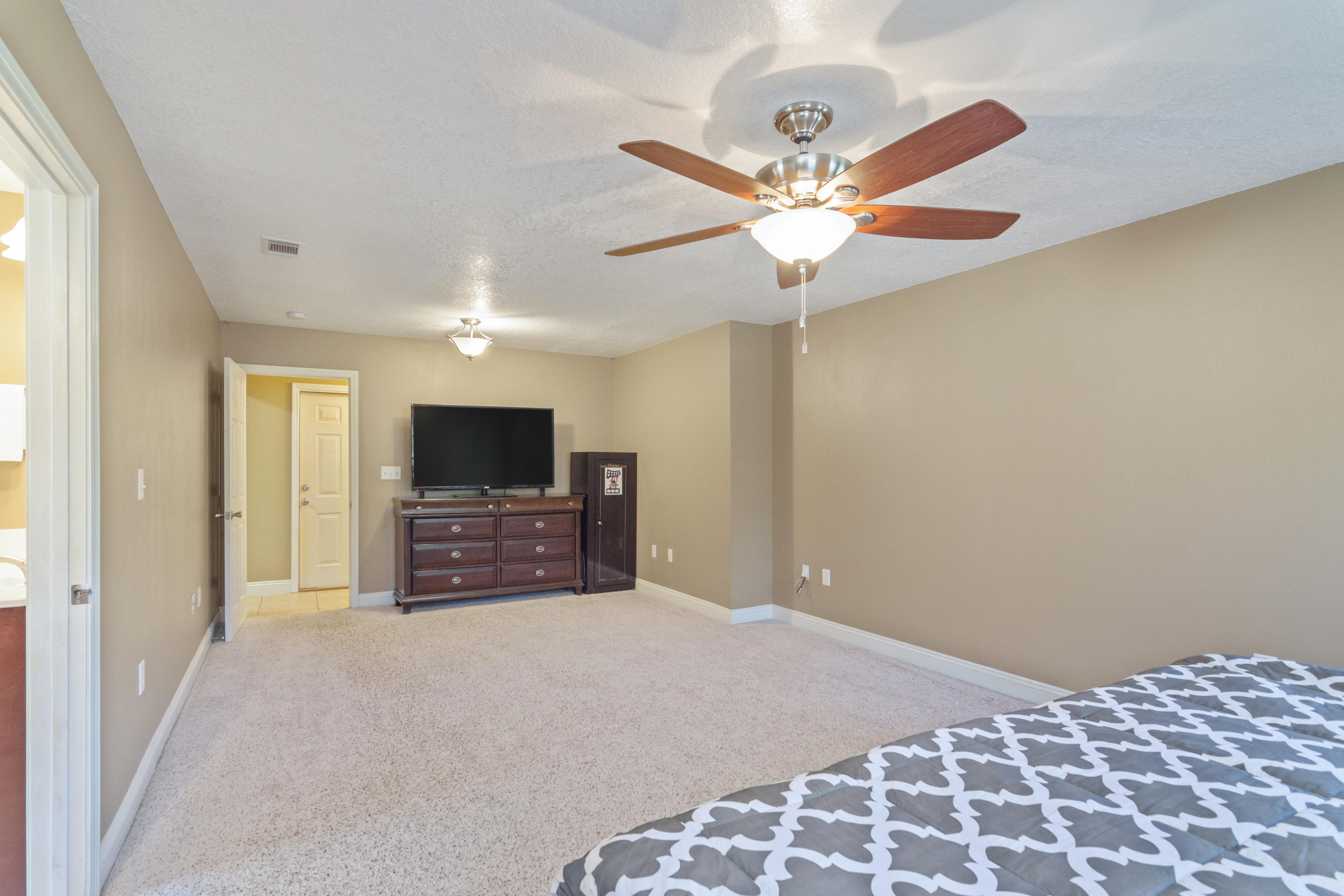 6589 Old River Road Baker, FL 32531 - Photo 32 of 49 a bedroom with a bed and a flat screen tv