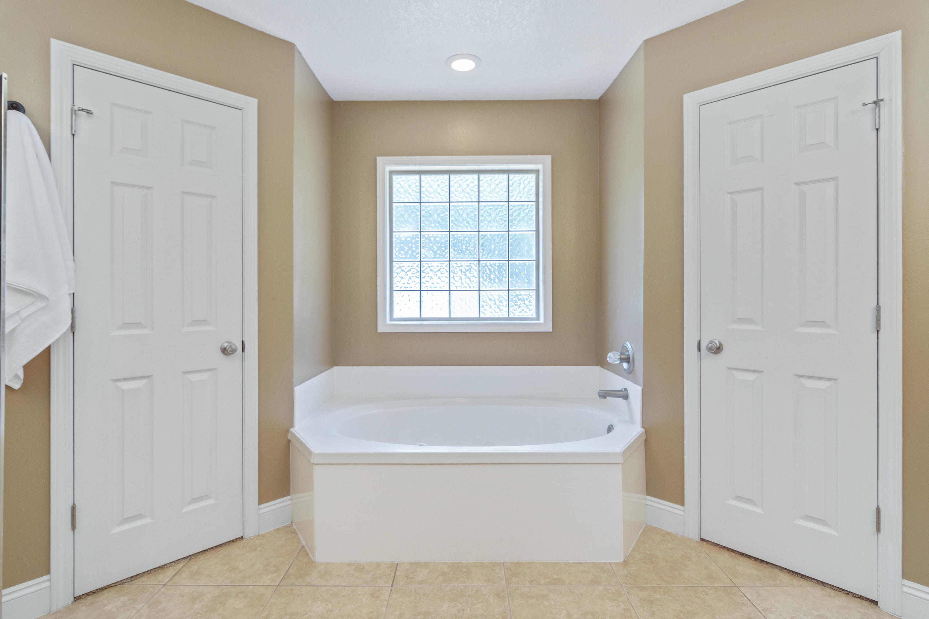 6589 Old River Road Baker, FL 32531 - Photo 33 of 49 a white bath tub sitting in a spacious bathroom next to a window