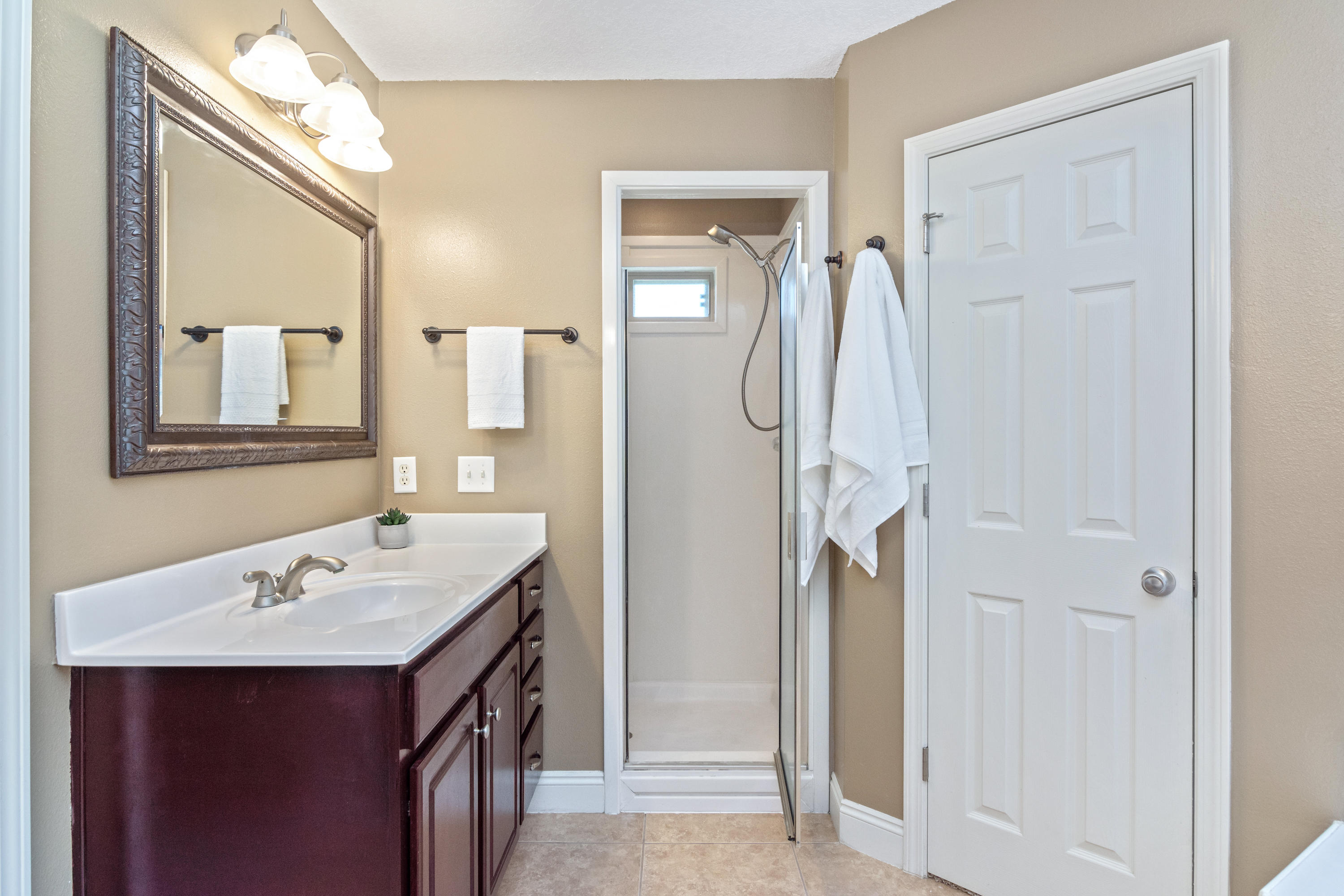 6589 Old River Road Baker, FL 32531 - Photo 34 of 49 a bathroom with a sink vanity and a mirror