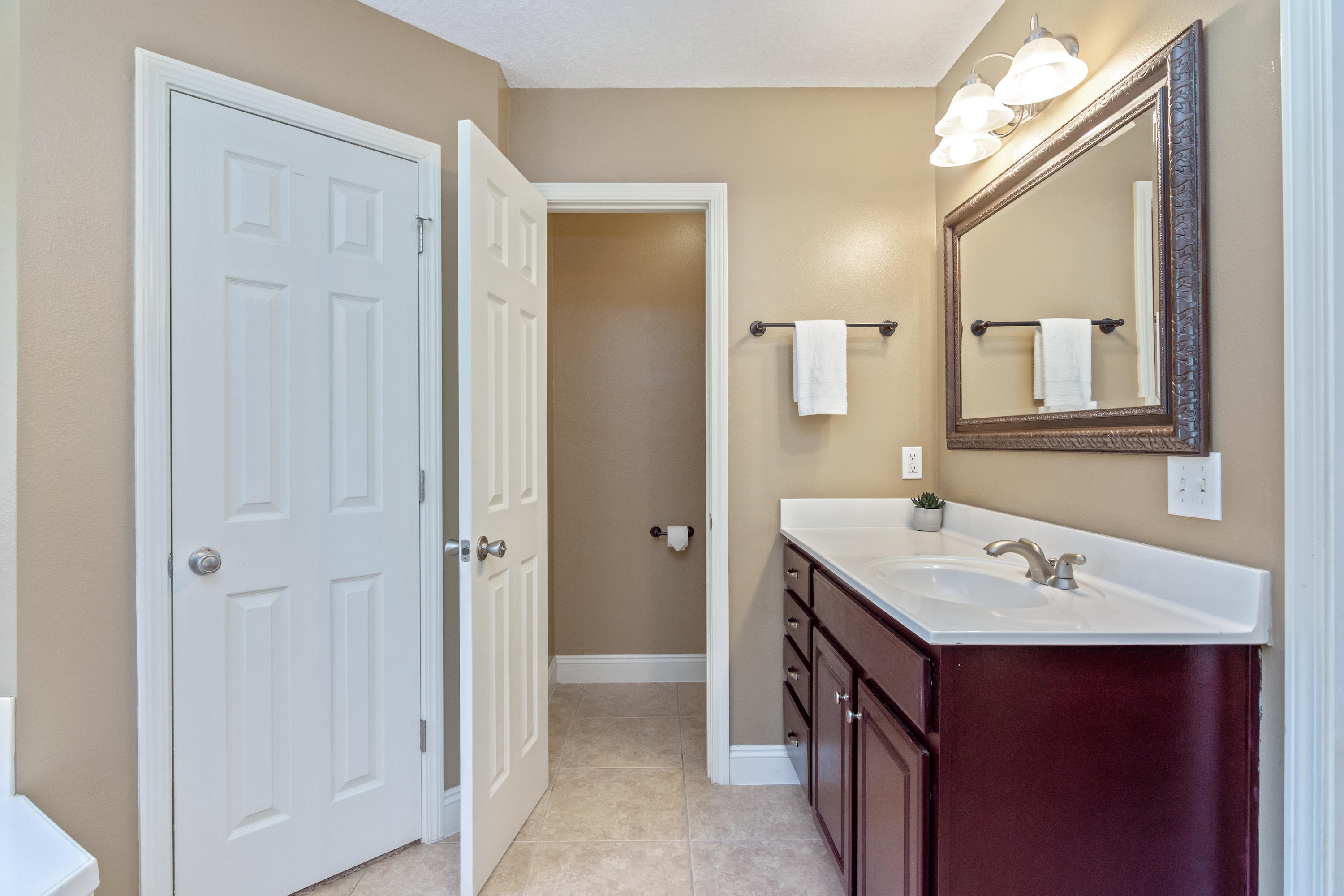 6589 Old River Road Baker, FL 32531 - Photo 35 of 49 a bathroom with a double vanity sink mirror and