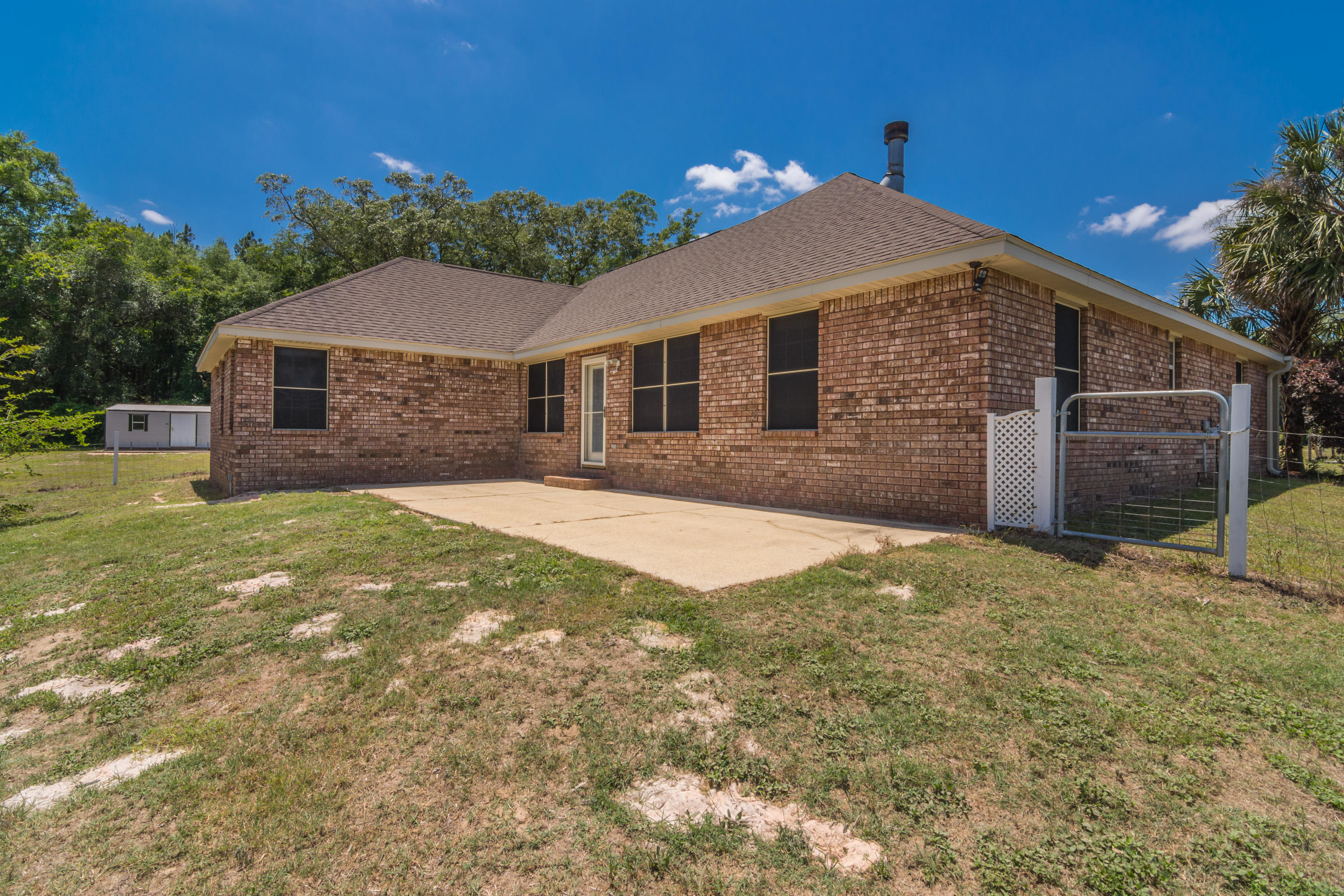 6589 Old River Road Baker, FL 32531 - Photo 46 of 49 a front view of a house with a yard