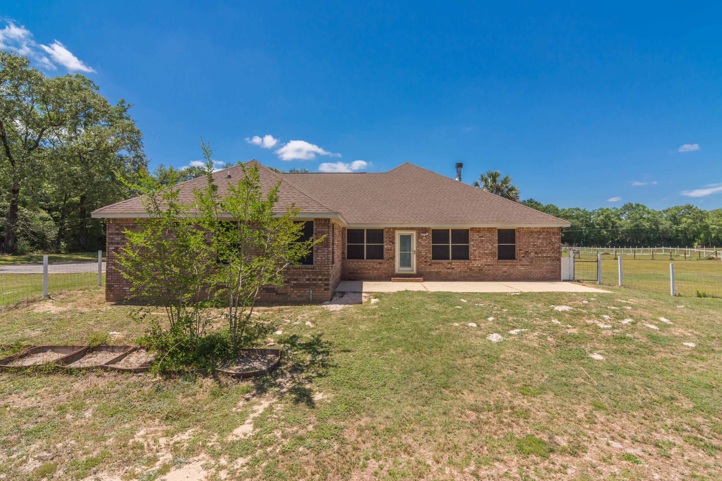 6589 Old River Road Baker, FL 32531 - Photo 47 of 49 a front view of a house with a yard