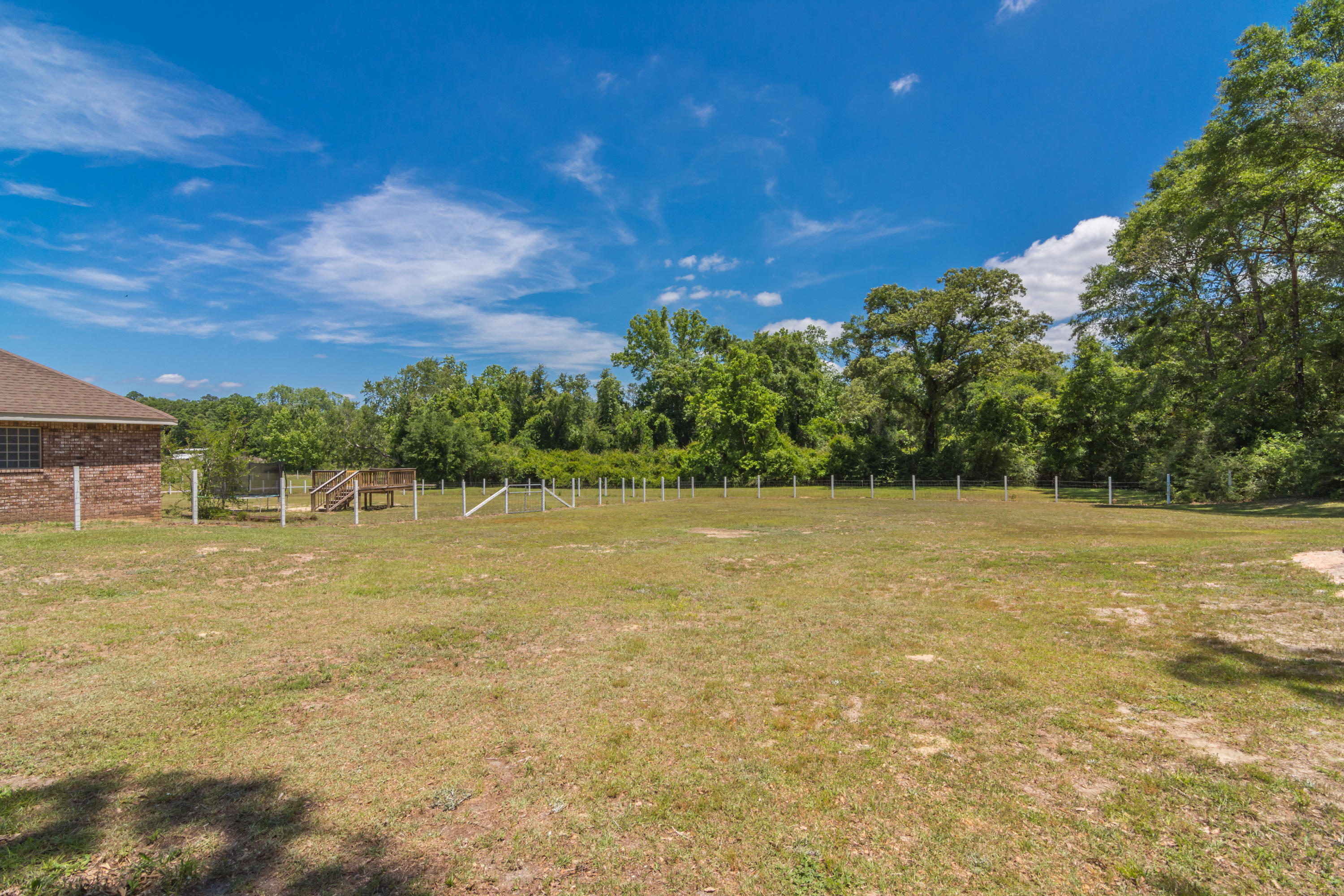 6589 Old River Road Baker, FL 32531 - Photo 49 of 49 a view of a yard with a house