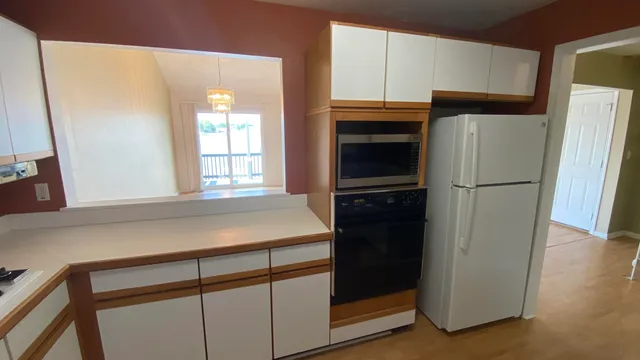 a kitchen with a refrigerator stove and cabinets